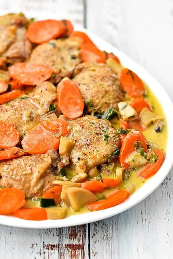 side angle shot of low fodmap instant pot chicken fricassee on a white platter
