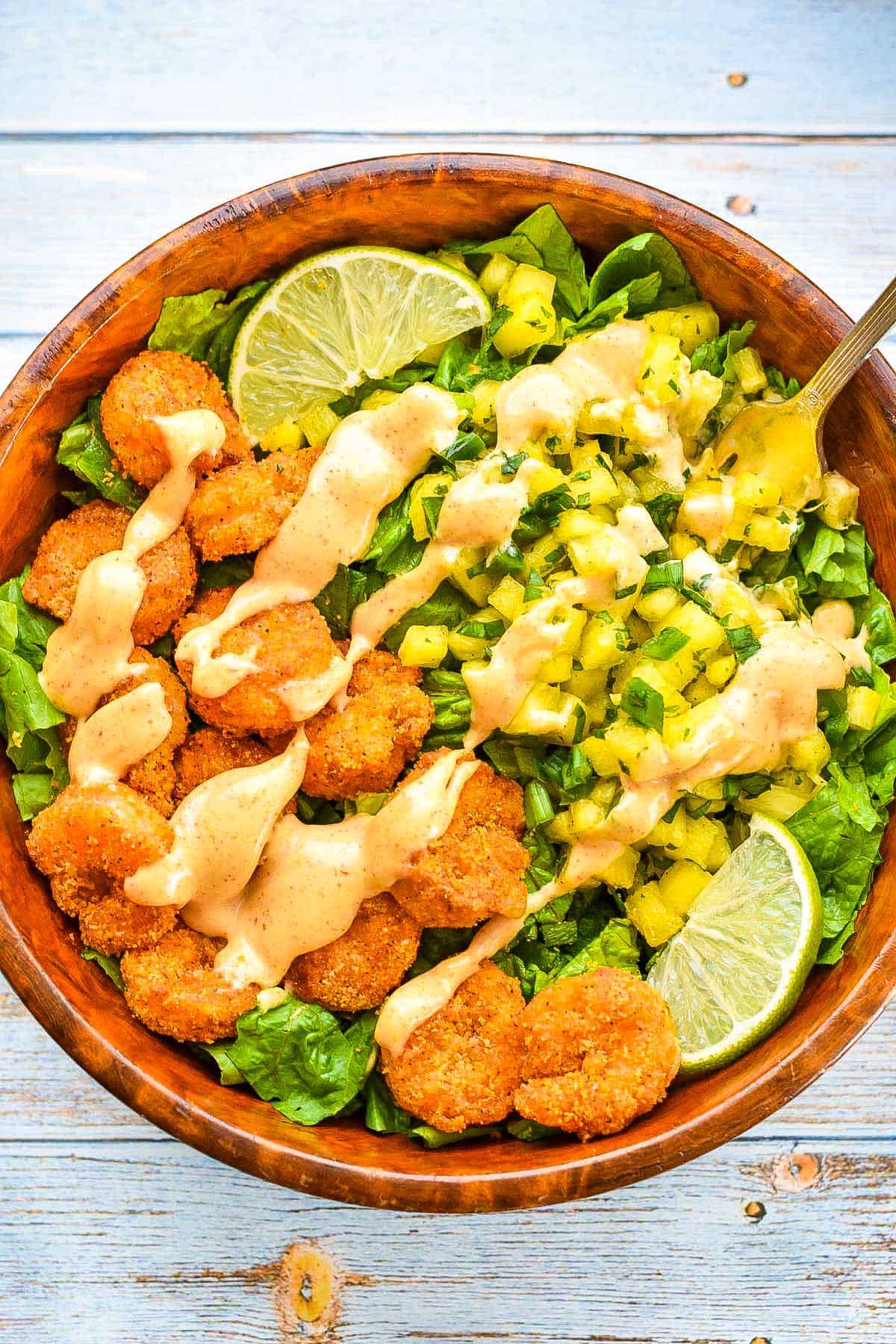 an overhead shot of a low fodmap air fryer shrimp taco bowl with pineapple salsa covered in chipotle mayo