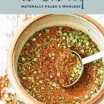 a bowl of low fodmap taco seasoning with low fodmap taco seasoning naturally paleo & whole30 written at the top and goodnomshoney.com at the bottom.
