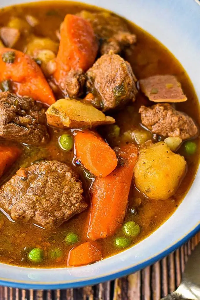 a close up of low fodmap instant pot / slow cooker beef stew with beef and vegetables in broth