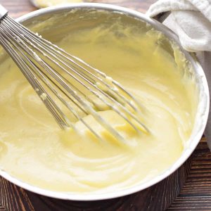 low fodmap bechamel white sauce in a pot with a whisk