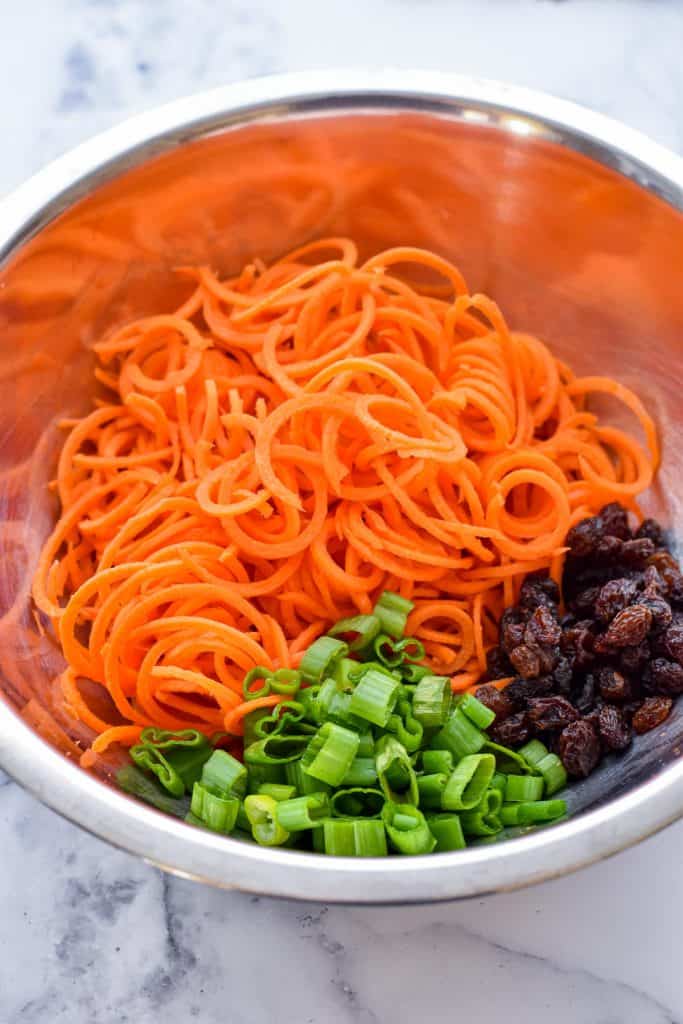 low fodmap carrot slaw produce ingredients in a metal mixing bowl