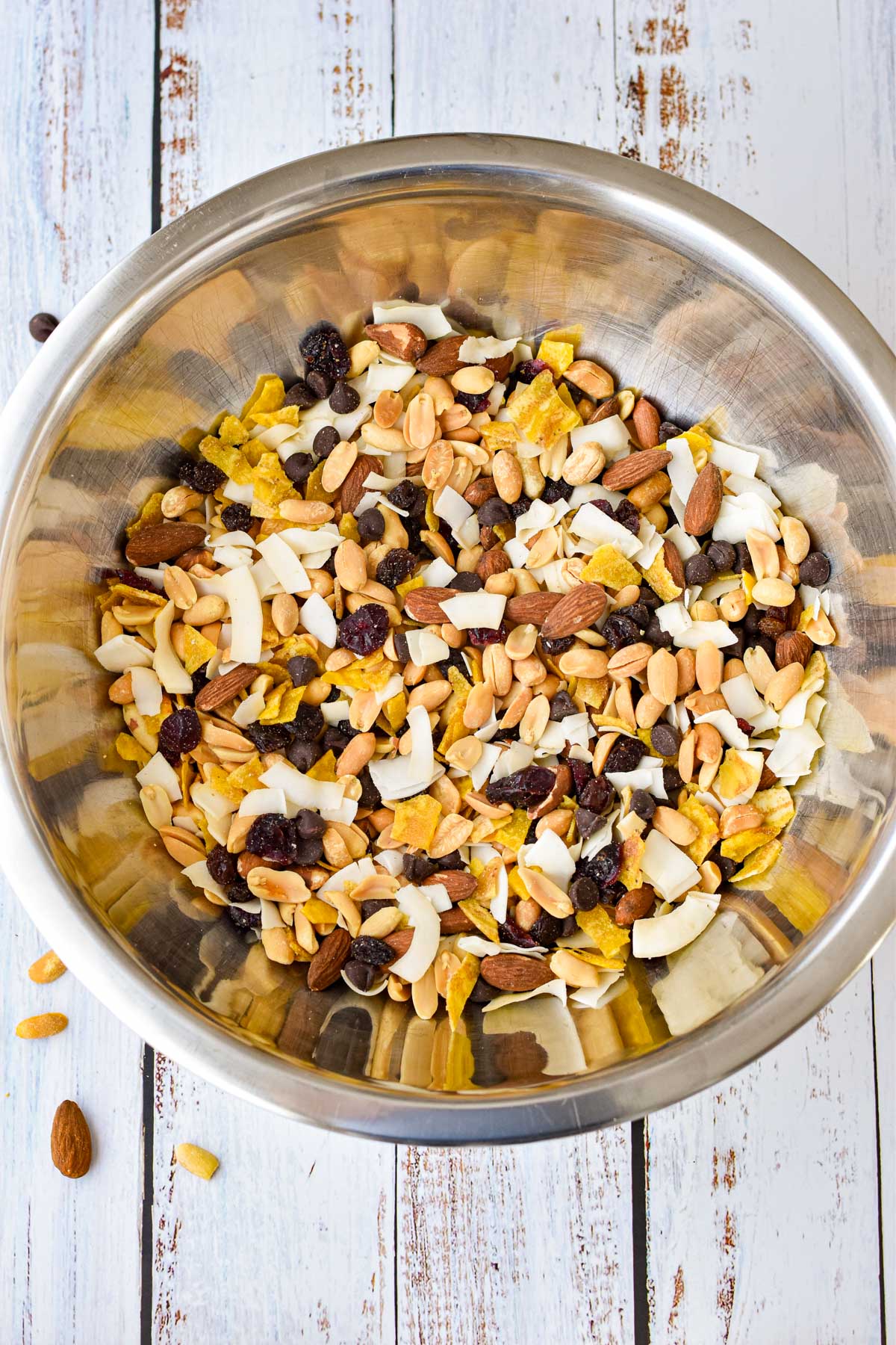 process shot of low fodmap trail mix ingredients mixed together in a mixing bowl