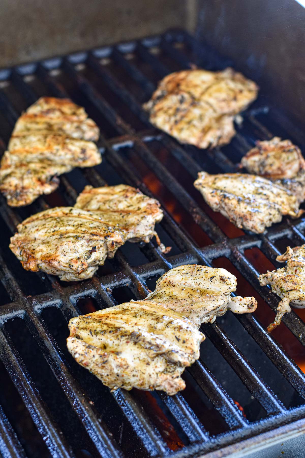 boneless chicken thighs grilling on on a natural gas Weber grill