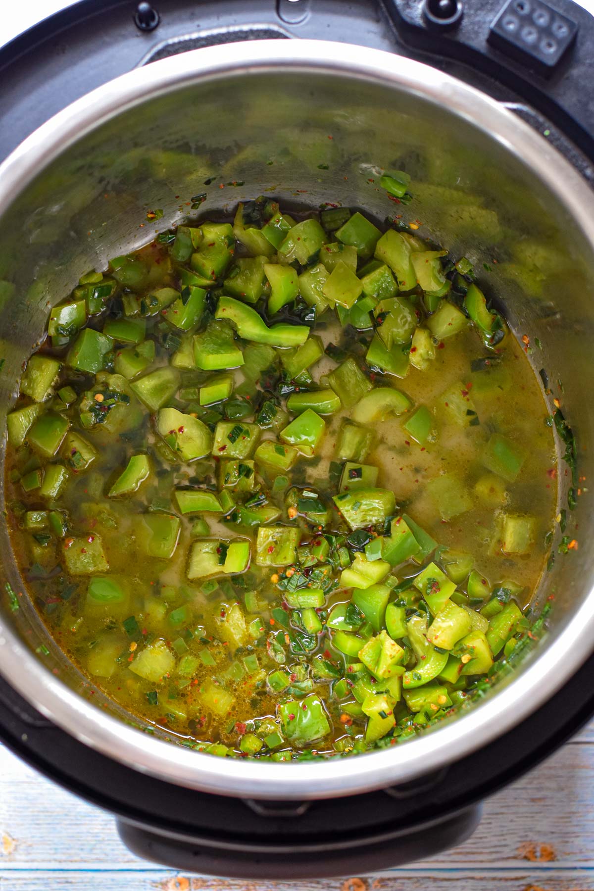 process shot of after water, vinegar and lime juice is added to the sautéed peppers and leeks