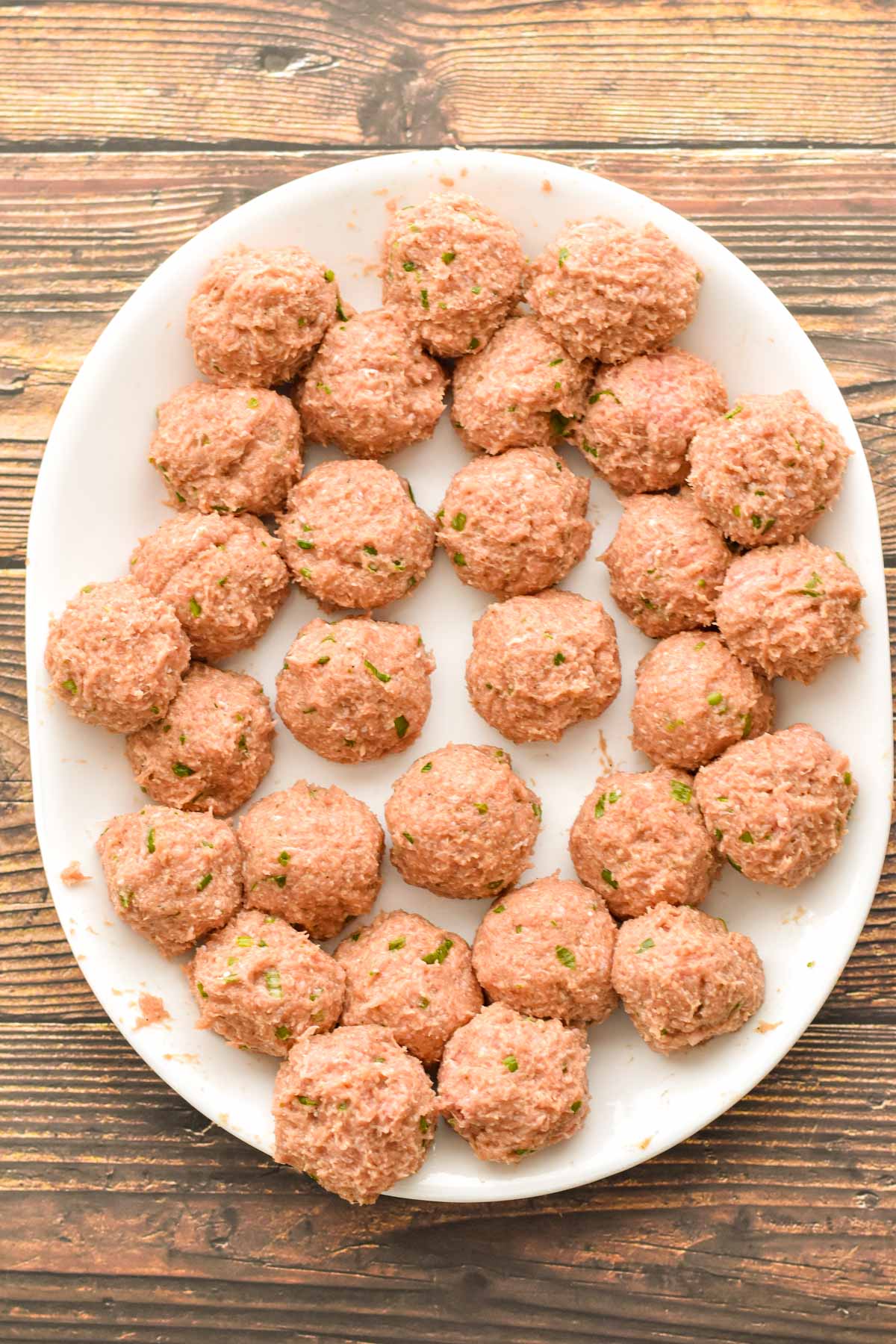 process shot of low fodmap turkey meatballs on a platter after all of the meatballs have been formed prior to cooking