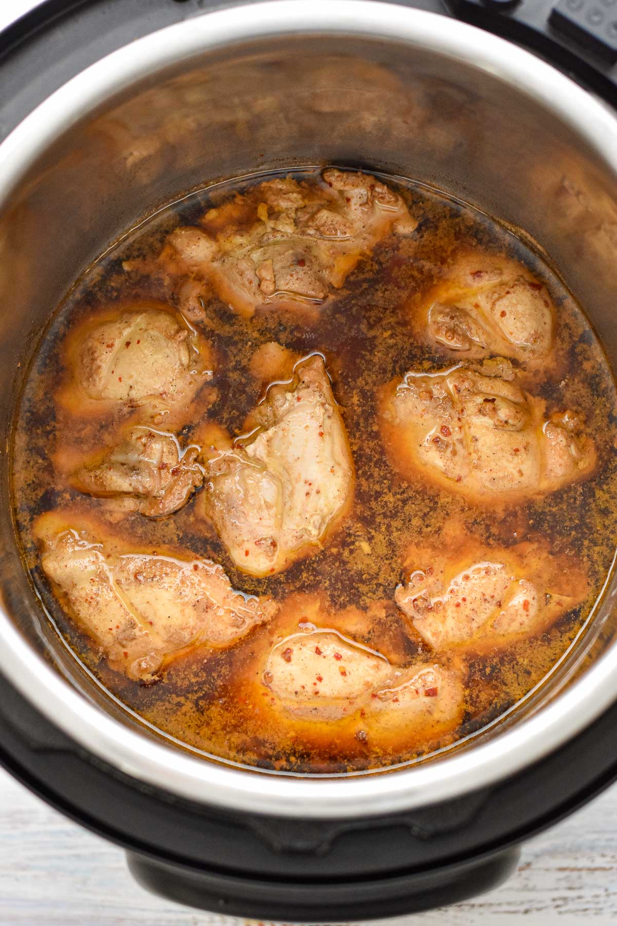 process shot of cooked chicken thighs in sauce in an instant pot