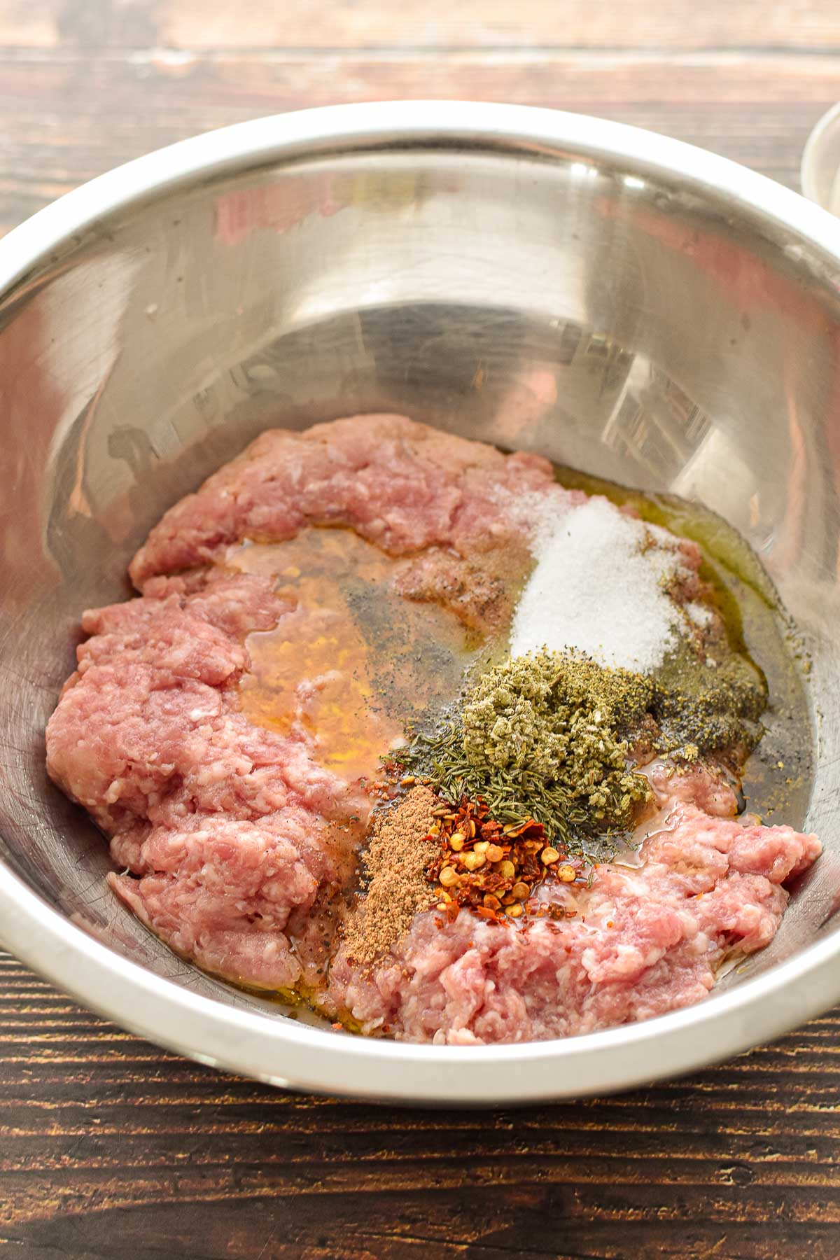 process shot of after low fodmap breakfast sausage ingredients are added to a large mixing bowl