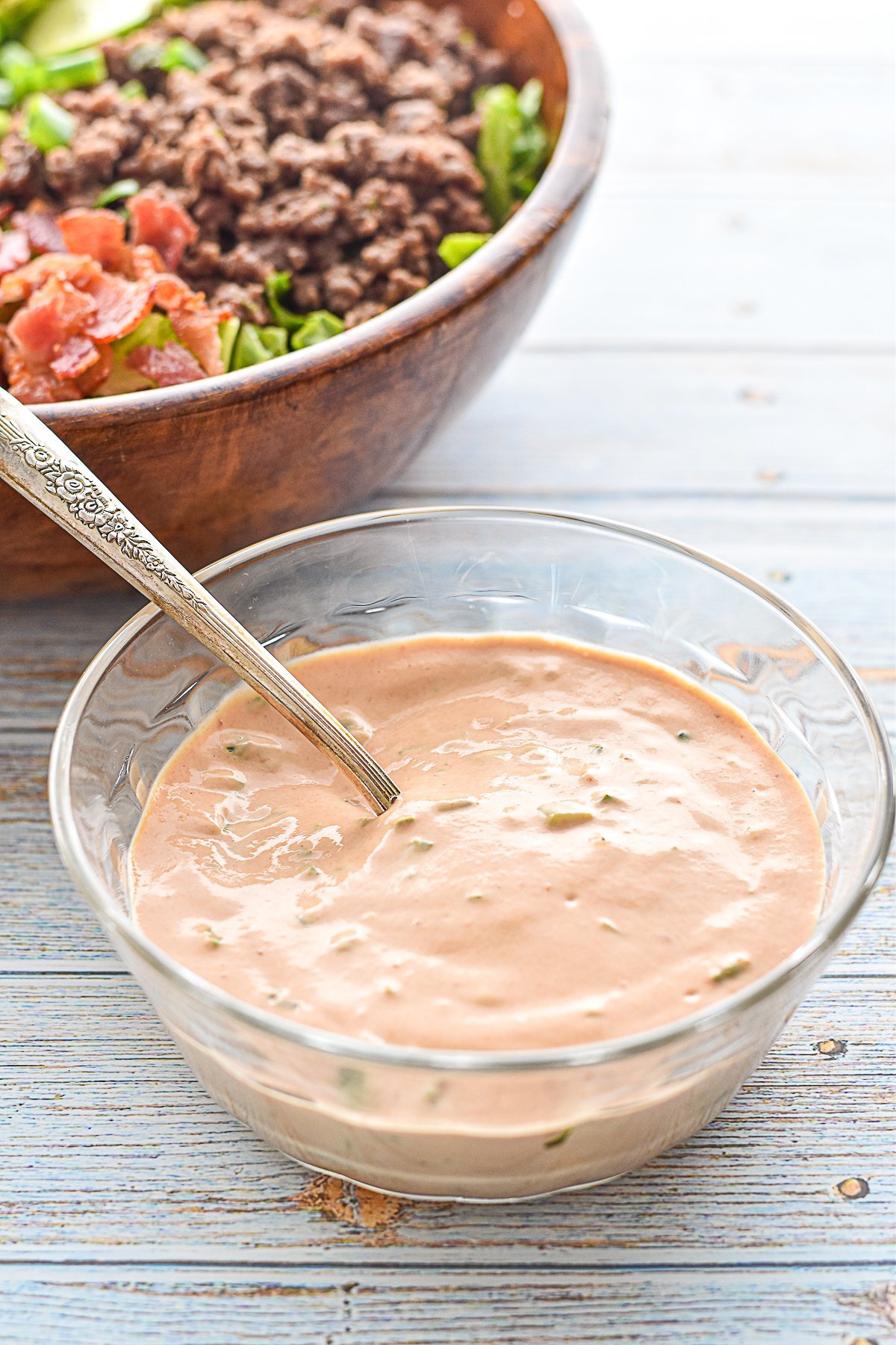 low fodmap burger sauce in a bowl with a spoon in front of a low fodmap burger bowl