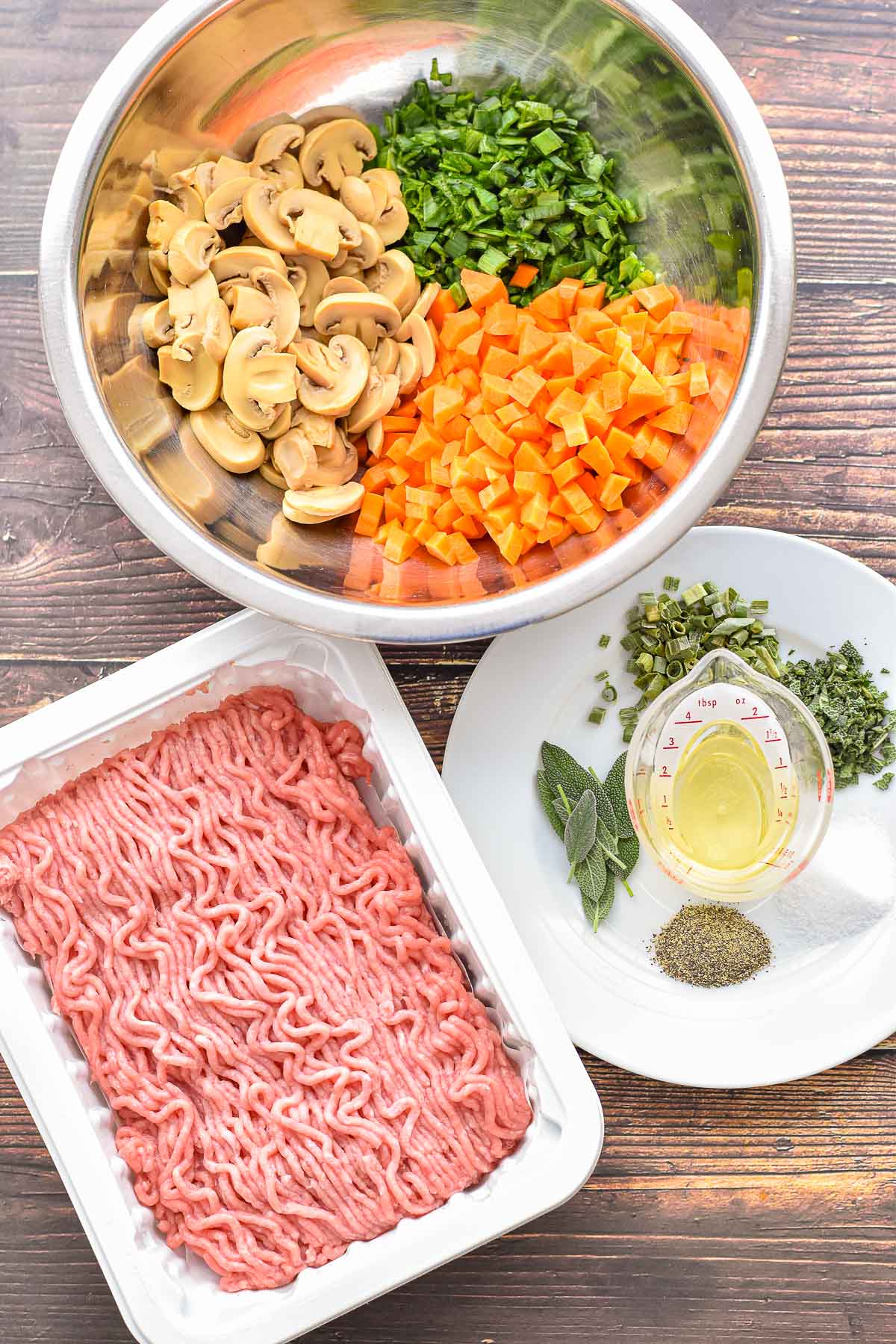 low fodmap low carb shepherd's pie turkey filling ingredients, including ground turkey, canned sliced mushrooms, finely chopped leek greens and carrots, garlic-infused olive oil, finely chopped fresh sage, dried choves, salt, pepper, and additional sage leaves for optional garnish.